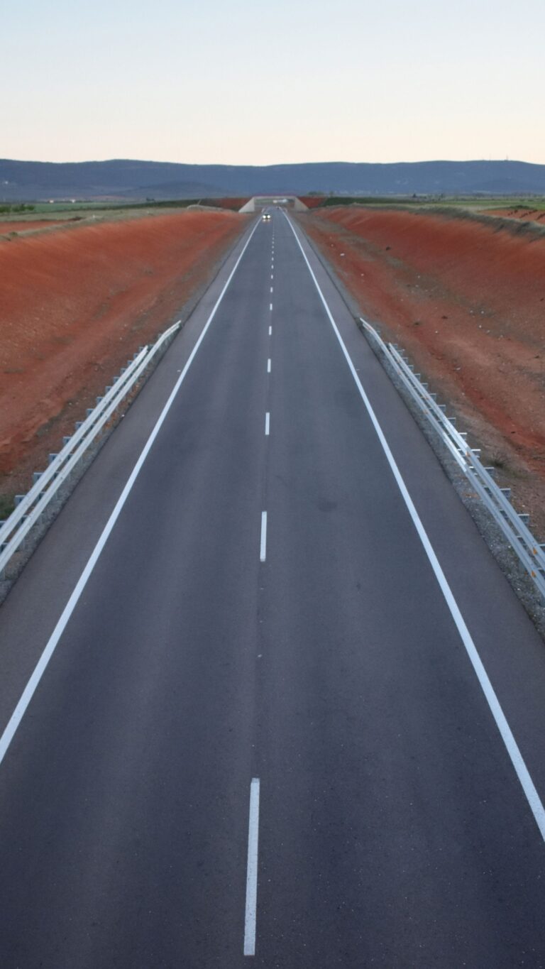 Lond empty road beside red land nature wallpaper for mobile phone Wallpaper background (Image-Photo-Picture) full HD free download.